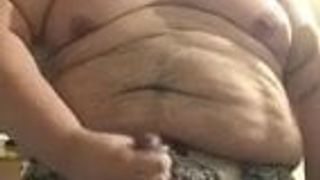Homem gordo se masturba e atira carga para todo mundo ver
