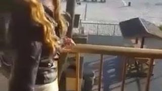 Girl plays with toy on balcony