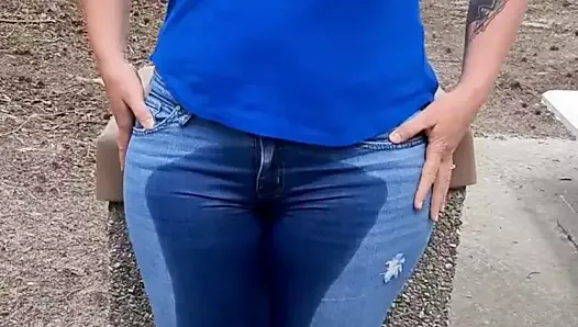 Kobieta moczy dżinsy w parku