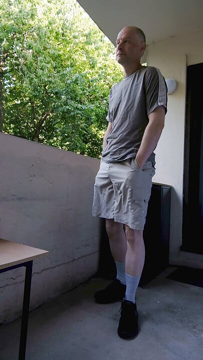 Horny wanker outside on balcony wanks flaccid uncut cock as he strips gets erect penis shows asshole  proudly exposing himself