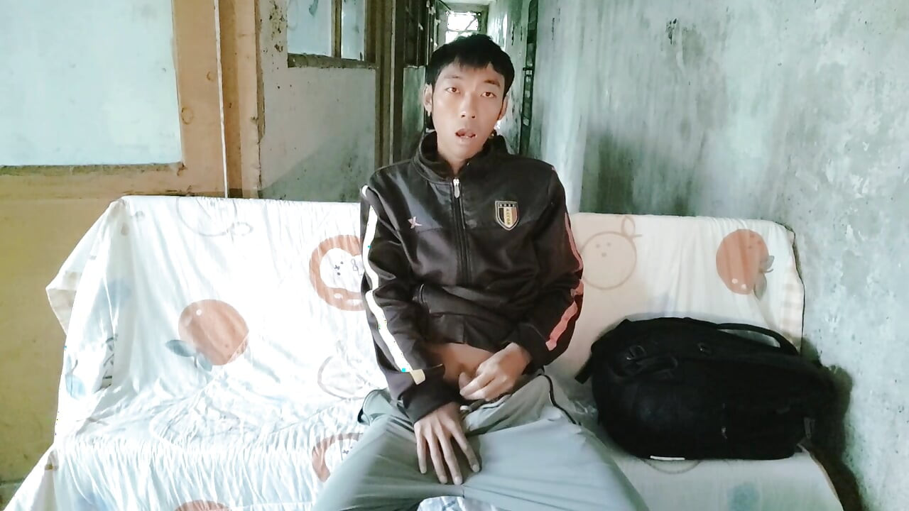 Naughty Asian boy masturbates, moans, cums and eats cum on a lounge chair in an abandoned laboratory corridor
