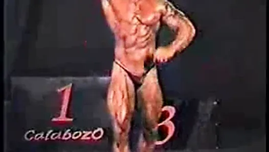 Bodybuilder's dick comes over top of posers on stage