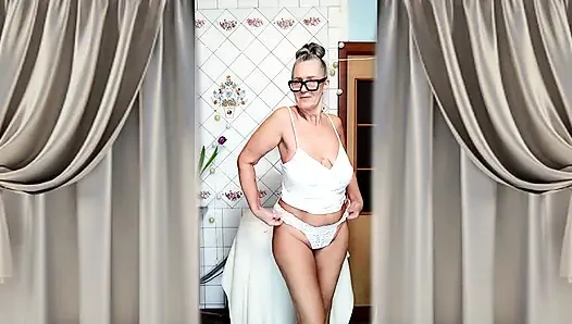 Hot mature housewife Lukerya undresses and teases with her huge tits in the kitchen