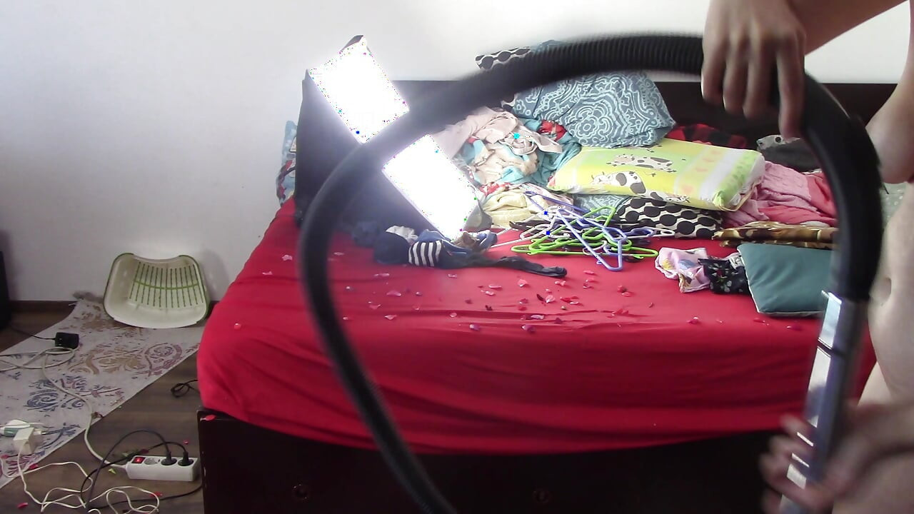 Amateur wife cleans the house with the vacuum cleaner. Sexy has fun with roses naked.