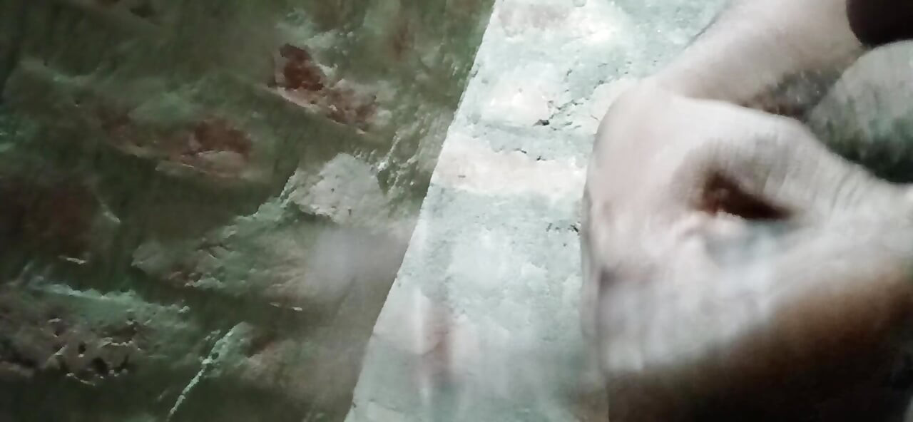 Gay guy spanking his cock in the bathroom
