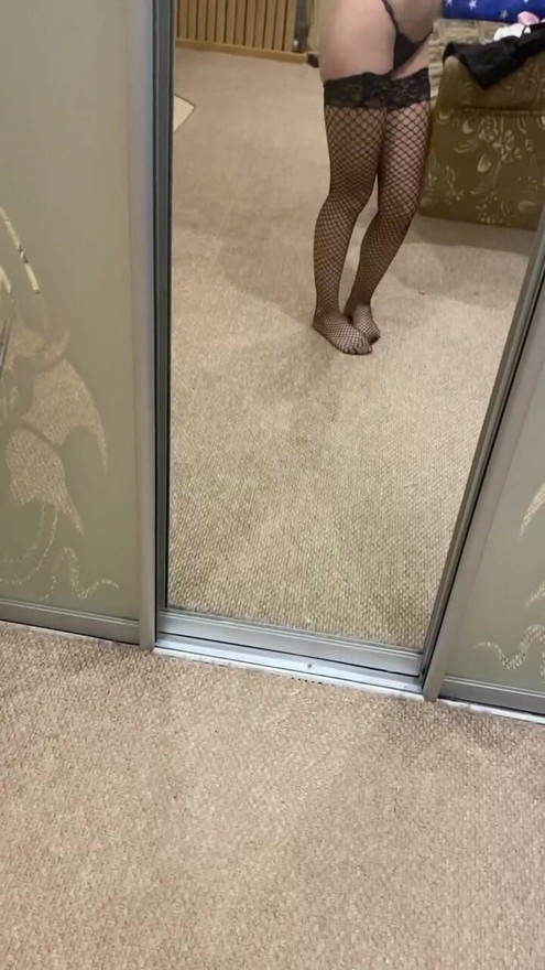 posing in stockings at the mirror