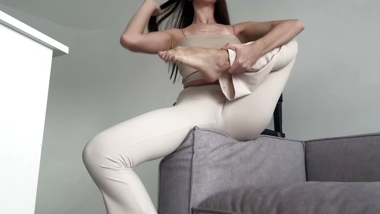 Yoga at home on the sofa with flexible girl