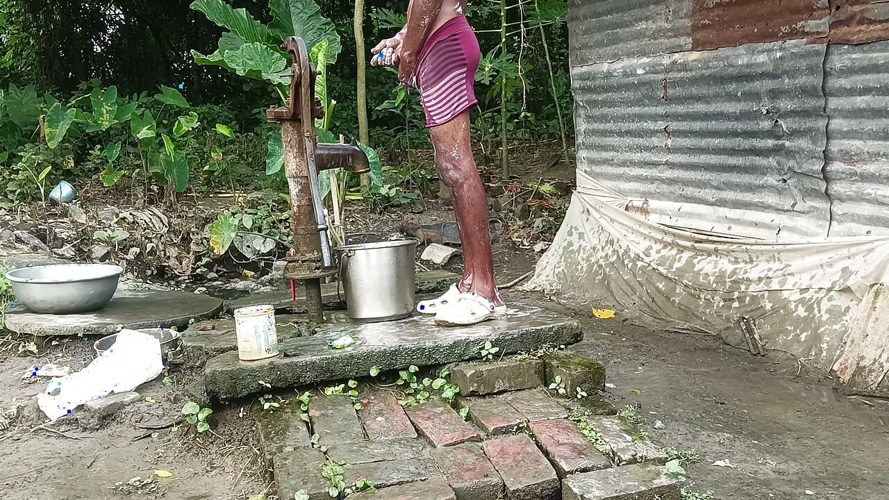 Black mature man bath in desi style. Showing big dick.