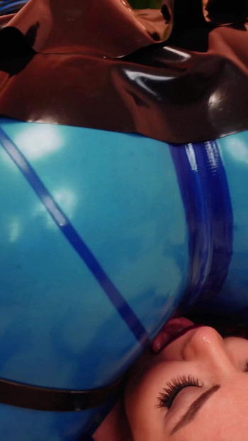 Iconic moment from "Lesbian Dildo Suck and Latex Facesitting - AryaGrander - Dominatrix and rubber submissive girl"