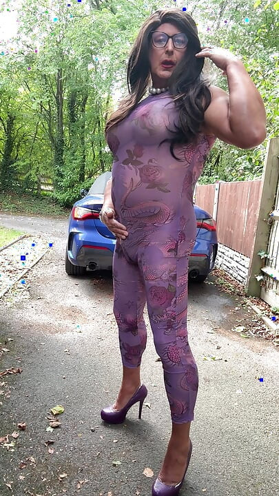 Sexy Crossdresser kellycd2022 in purple catsuit and heels outdoors