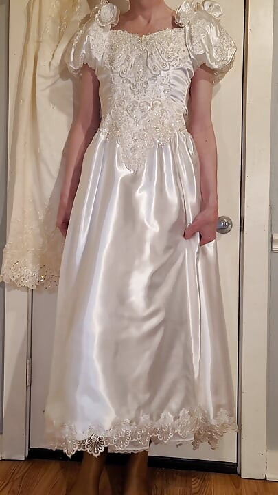 Trying on a liquid satin wedding dress.