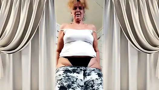 Cheerful housewife Lukerya in a homely atmosphere in the kitchen.