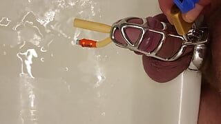 Pissing with catheter locked in chastity cage