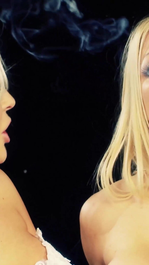Gorgeous blonde girls rubbing each other's legs while smoking cigarettes | Clip 1