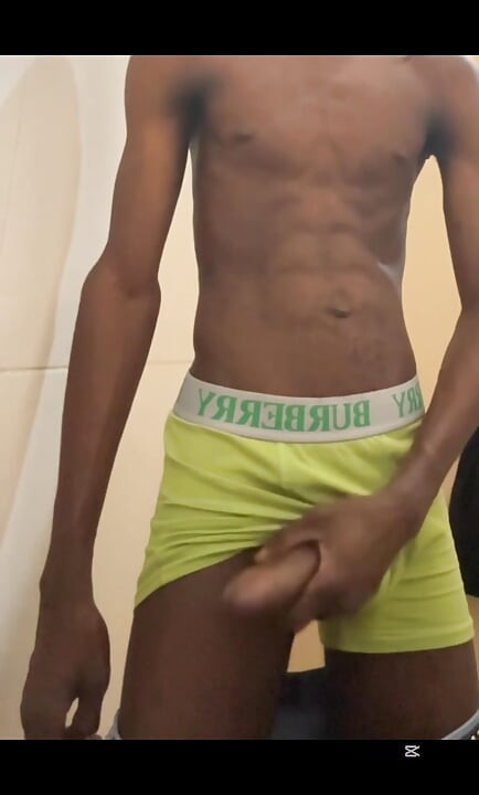 Sexy teen with abs stroking his big black cock in public