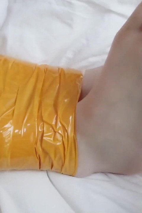 First-person Perspective Records the Girlfriend Wrapped in Tape From Head to Toe with Her Beautiful Bare Feet