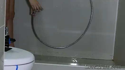 Desperate nude brunette empty her bladder in the bathroom