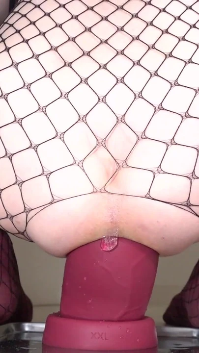 Jaw-dropping moment from "Fishnet Sissy 2025#04 - Riding a Black and Red huge dildo -"