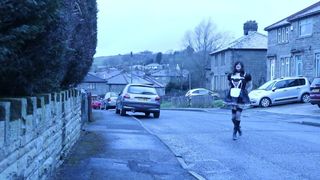 French maid crossdresser outdoors on a council estate