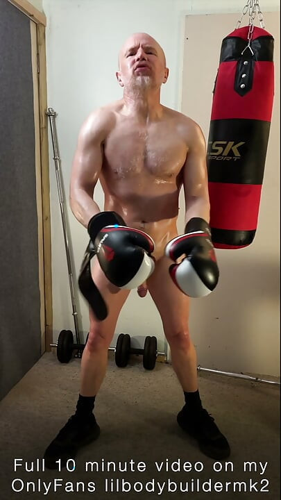 Oiled up big muscle Daddy boxing a punch bag naked, getting turned on and flexing his huge muscles