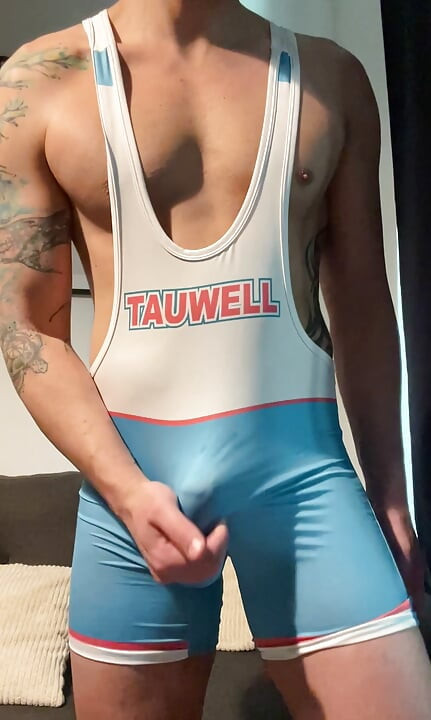 Smooth jock in wrestling singlet jerks off and cums