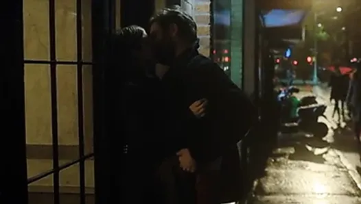 Anna Kendrick making out in front of a building