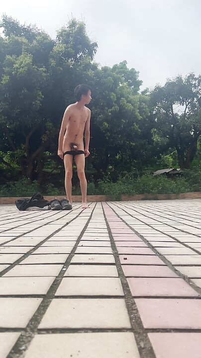 A young man publicly displays his erect penis.