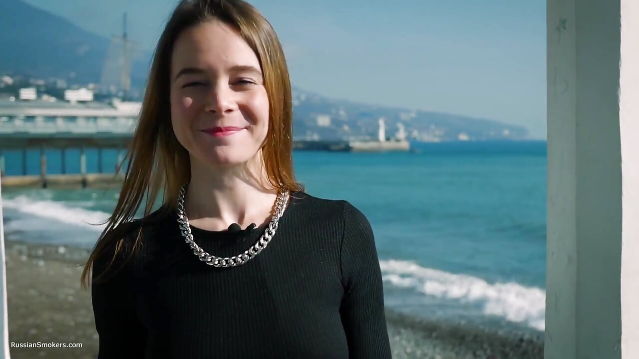 Une jeune Russe fume une cigarette à la mer