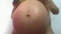 Pregnant slut teases on cam with dark nipples