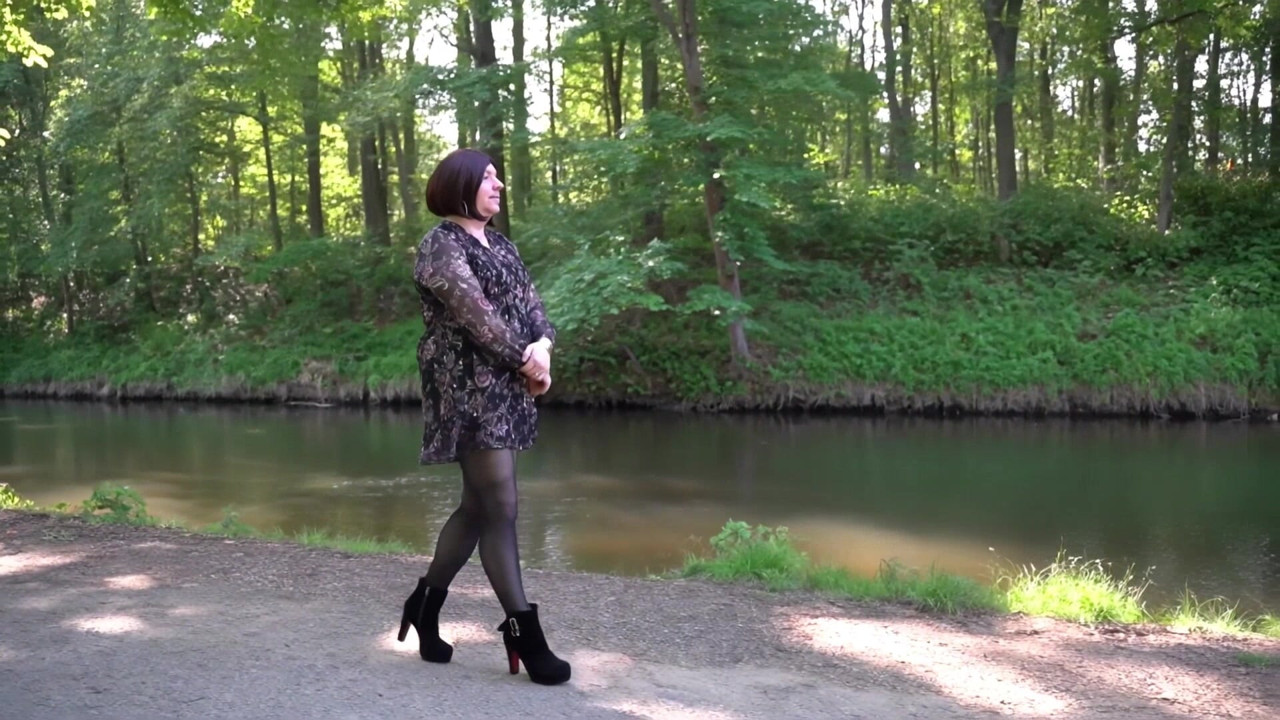 Nicolette in a great dress, tights and ankle boots goes for a walk in the forest (KI)