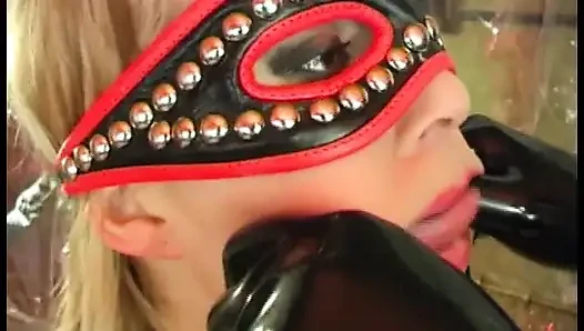 Dirty slave in fetish leather fucked by a sex toy