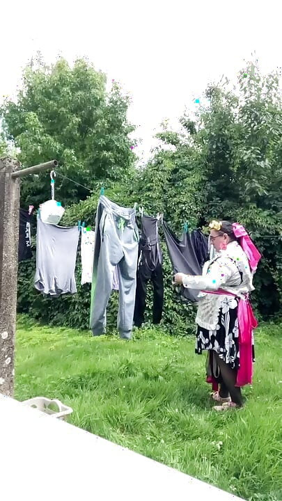 In gardening outfit to hang the laundry