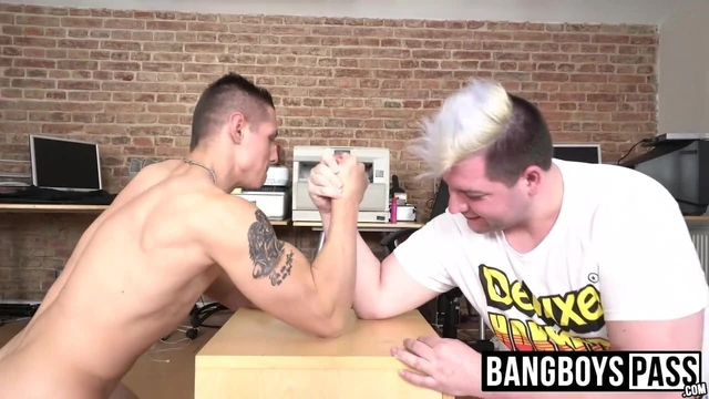 Fat wink and a muscular hunk have an arm wrestling contest