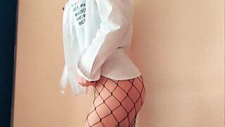 Striptease from a girl in a shirt and fishnet pantyhose