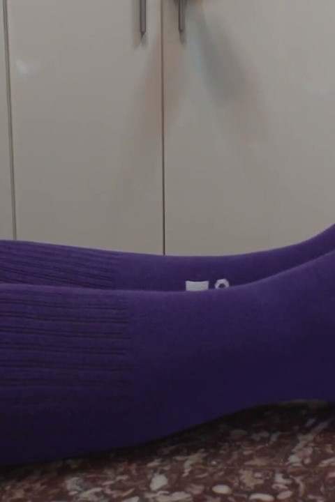 Mistress Sucking Lollypop with Long Socks on Her Feet