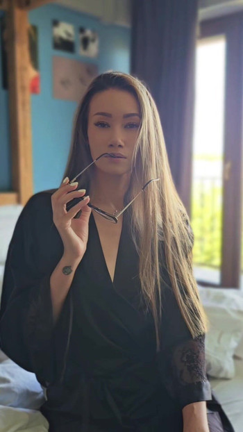 Hot asian woman with glasses in silk robe