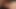 男性が大きな胸の赤毛ミルフにキスしながらカウガールの体位で彼女の膣を掘りつつ