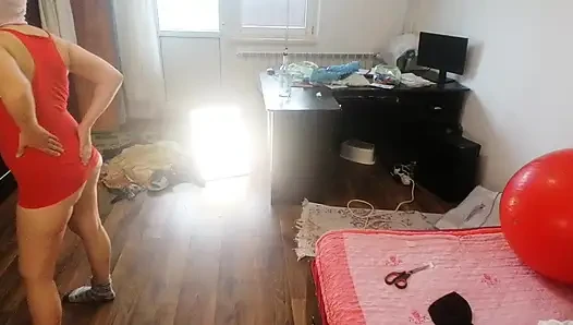 Amateur woman has fun trying on clothes and cutting them.