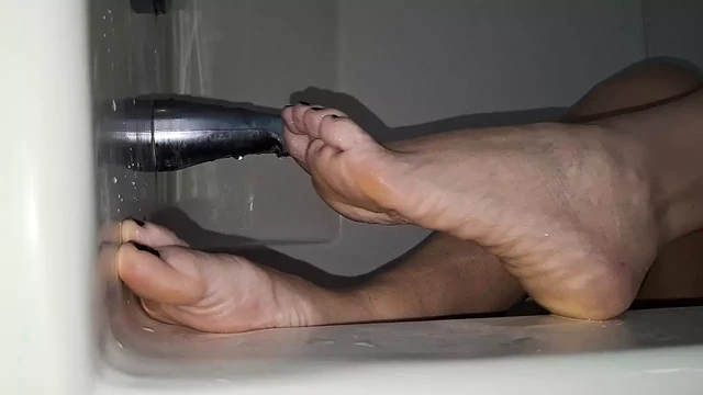 Showing off her beautiful feet in the bath