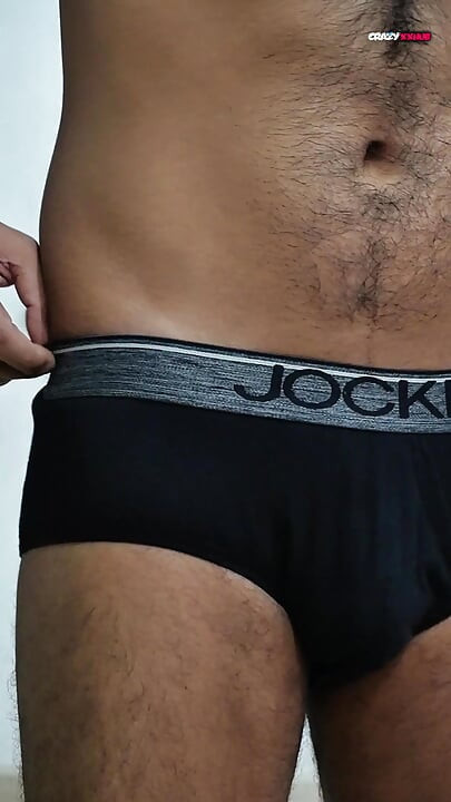 A sexy guy is dancing while holding his cock.