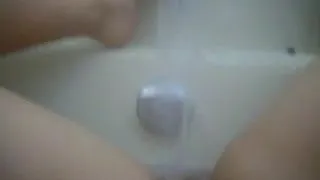 Girl cums in the bath with water from the faucet