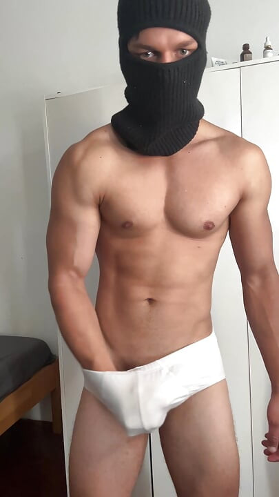 Young bodybuilder teasing in balaclava