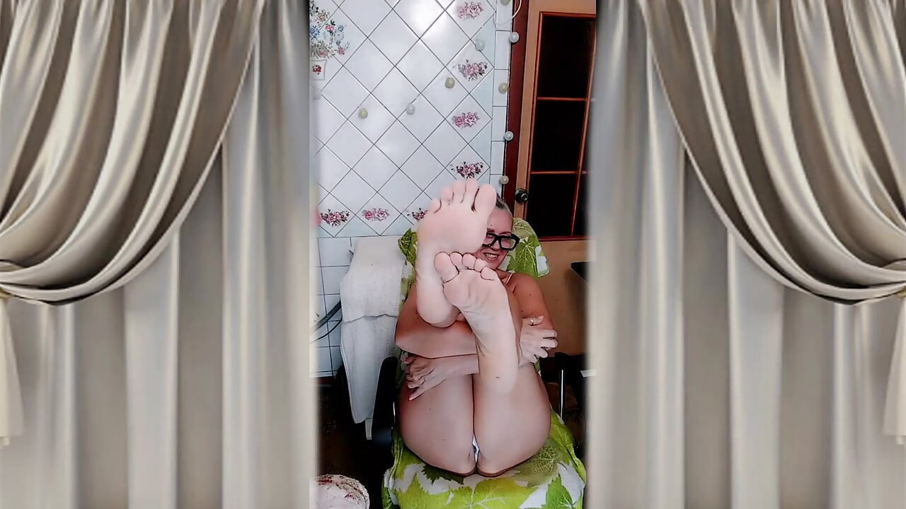 Hot housewife in the kitchen in home clothes.