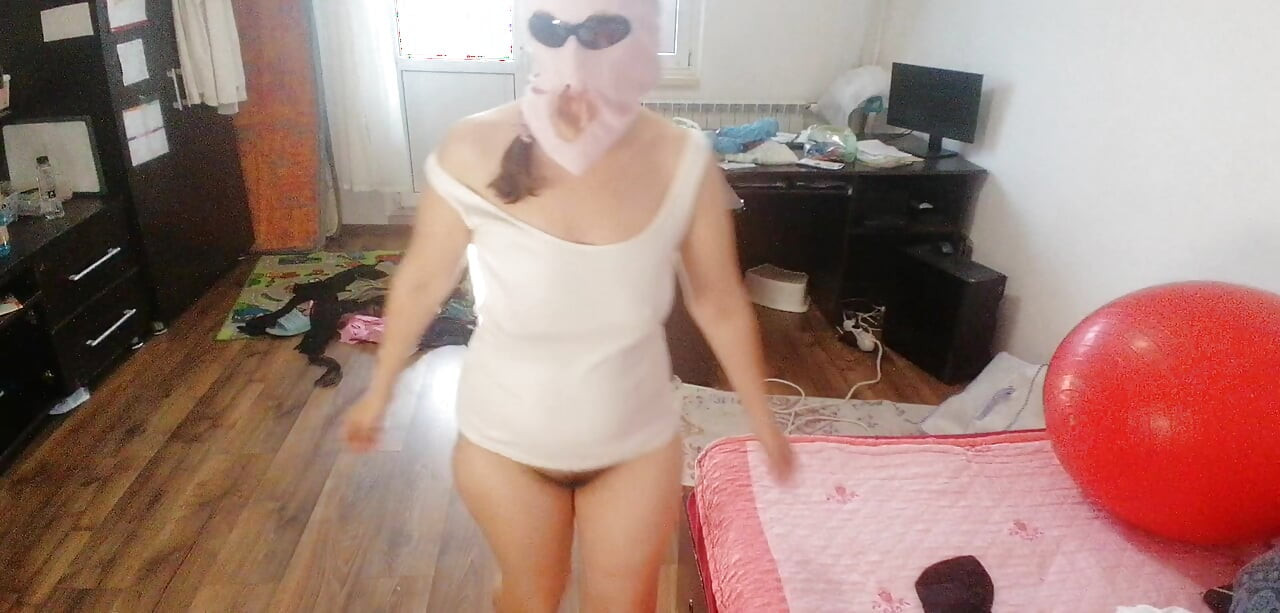 Amateur woman has fun trying on clothes and cutting them.