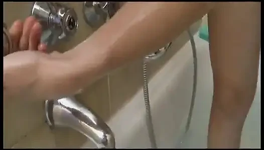 Mature woman takes a shower and fingers herself