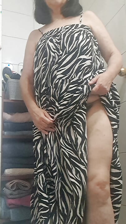 in the bathroom showing what's under her dress to her young lover on camera