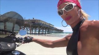 sexy leather biker in thigh boots on the beach