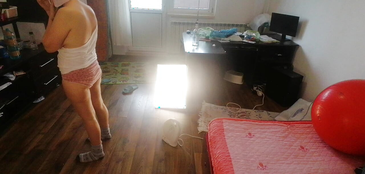 Amateur wife dancing naked at home. Amateur woman has fun trying on clothes and cutting them.