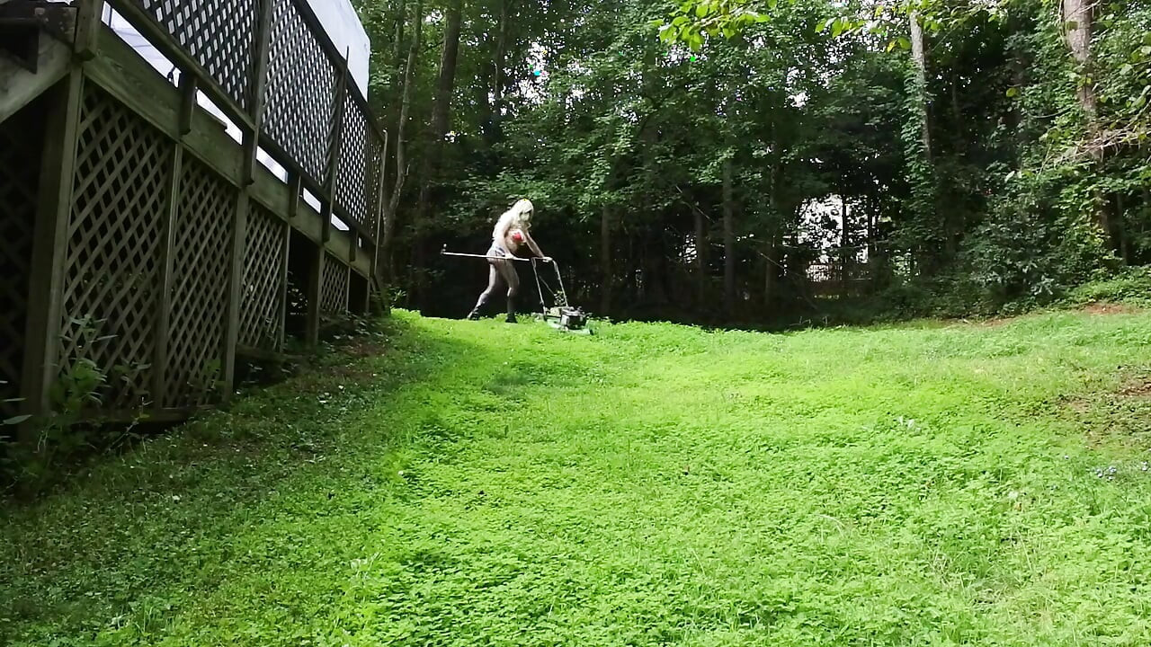 Big Fake Tits Crossdresser in Daisy Dukes Mowing Grass