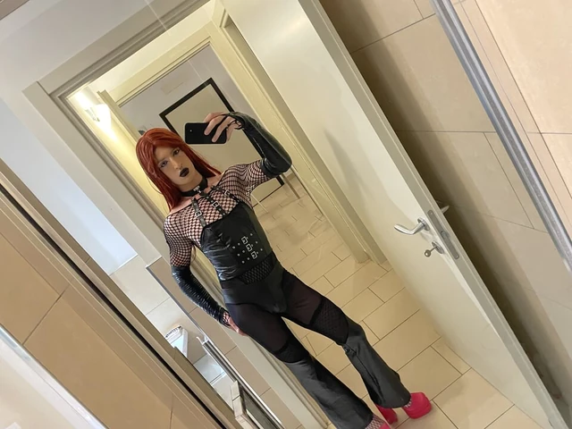Gothic sissy in chastity anally trains with her dildo, accompanied by valga and handcuffs